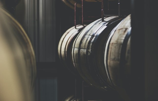 Whiskey barrels stacked on shelving